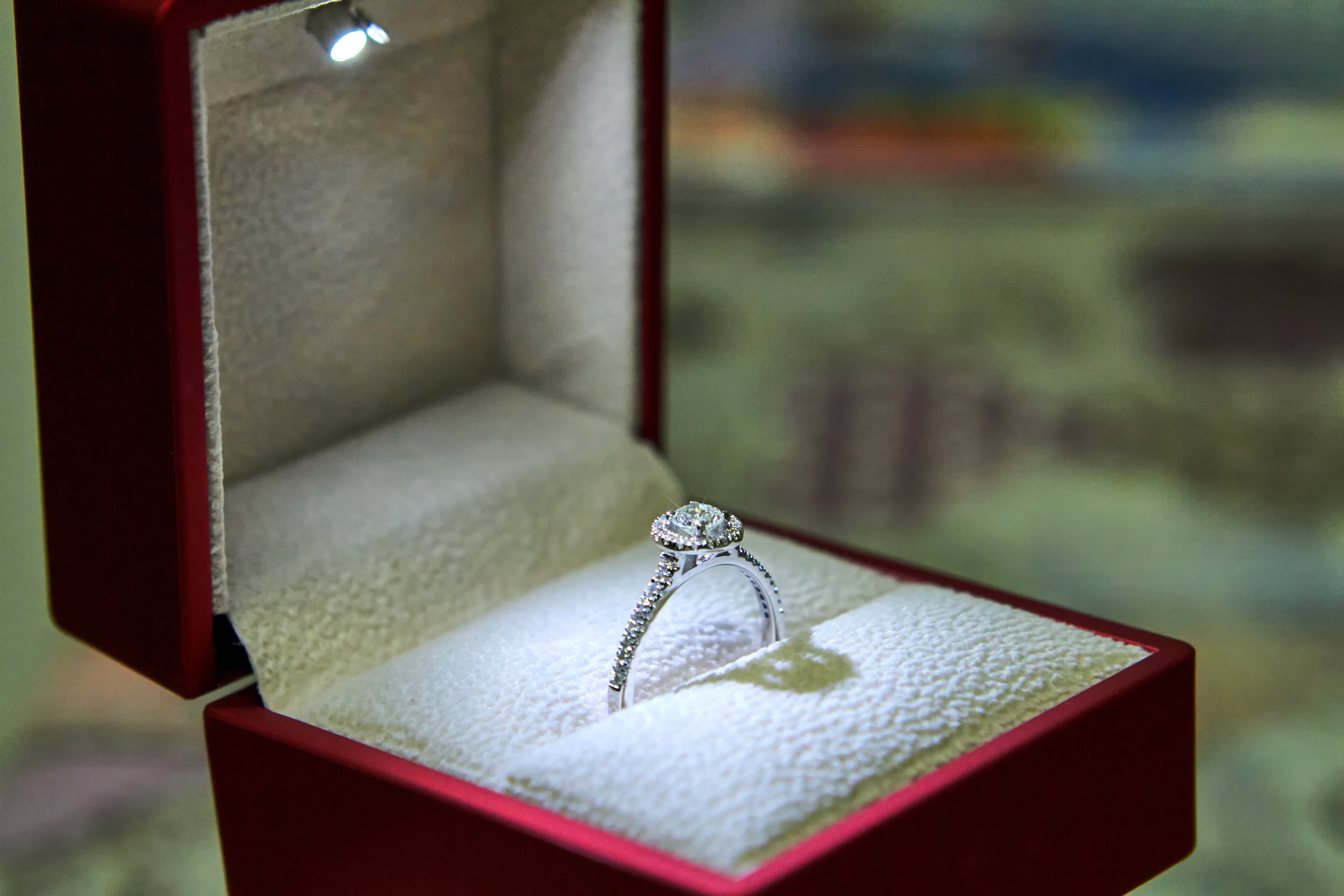 Jewelry production. White gold diamond ring in ice-lit gift box. Wedding, engagement, marriage proposal.