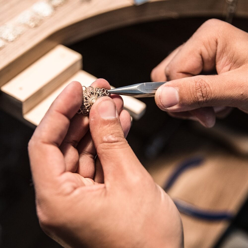 Jewelry maker creating a golden piece. High quality photo